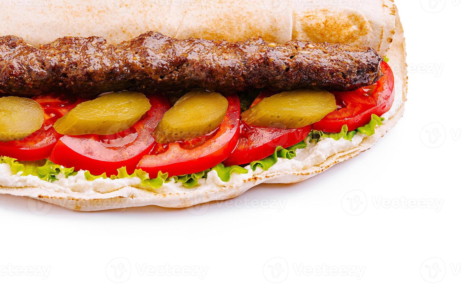 Delicious kebab sandwich with fresh vegetables close up photo