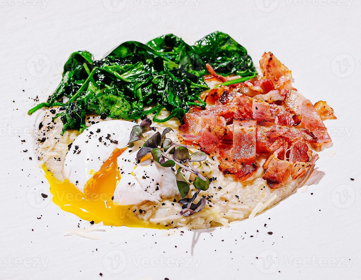 Attractive poached egg with spinach and crispy bacon photo