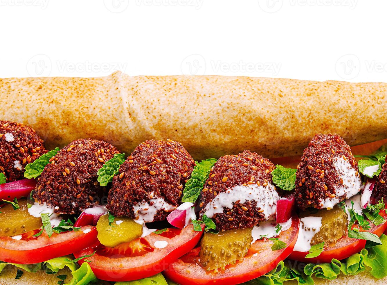 Savory falafel wrap filled with fresh vegetables and sauce photo