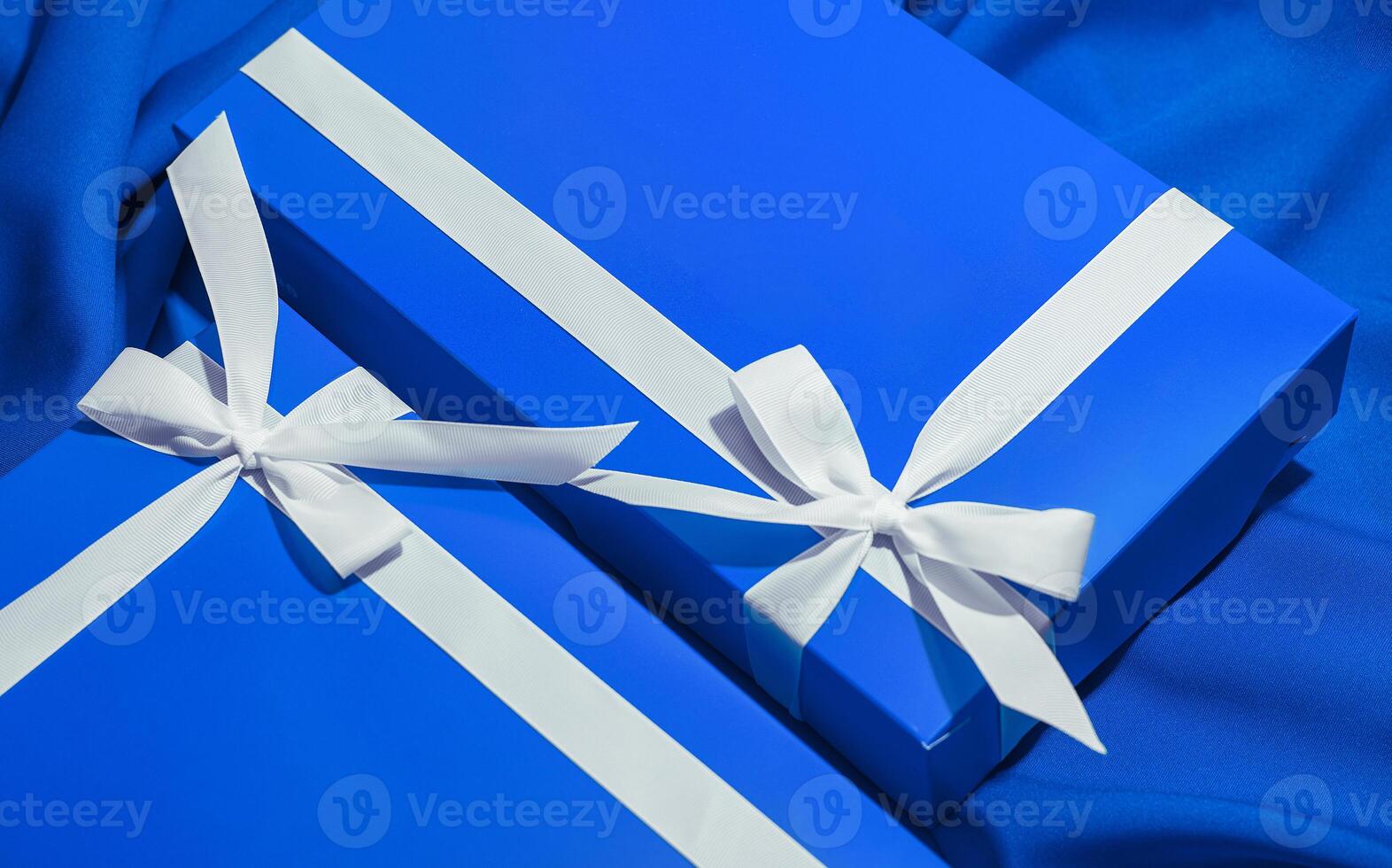 Elegant blue gift boxes with white ribbons photo
