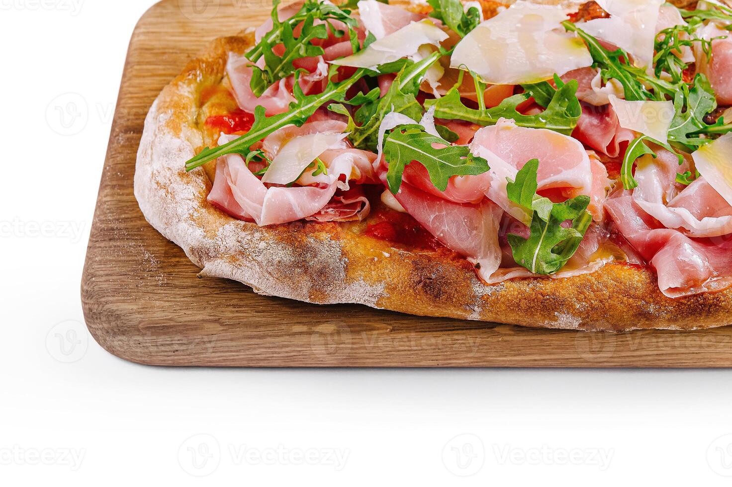 Gourmet italian pizza with prosciutto and arugula close up photo