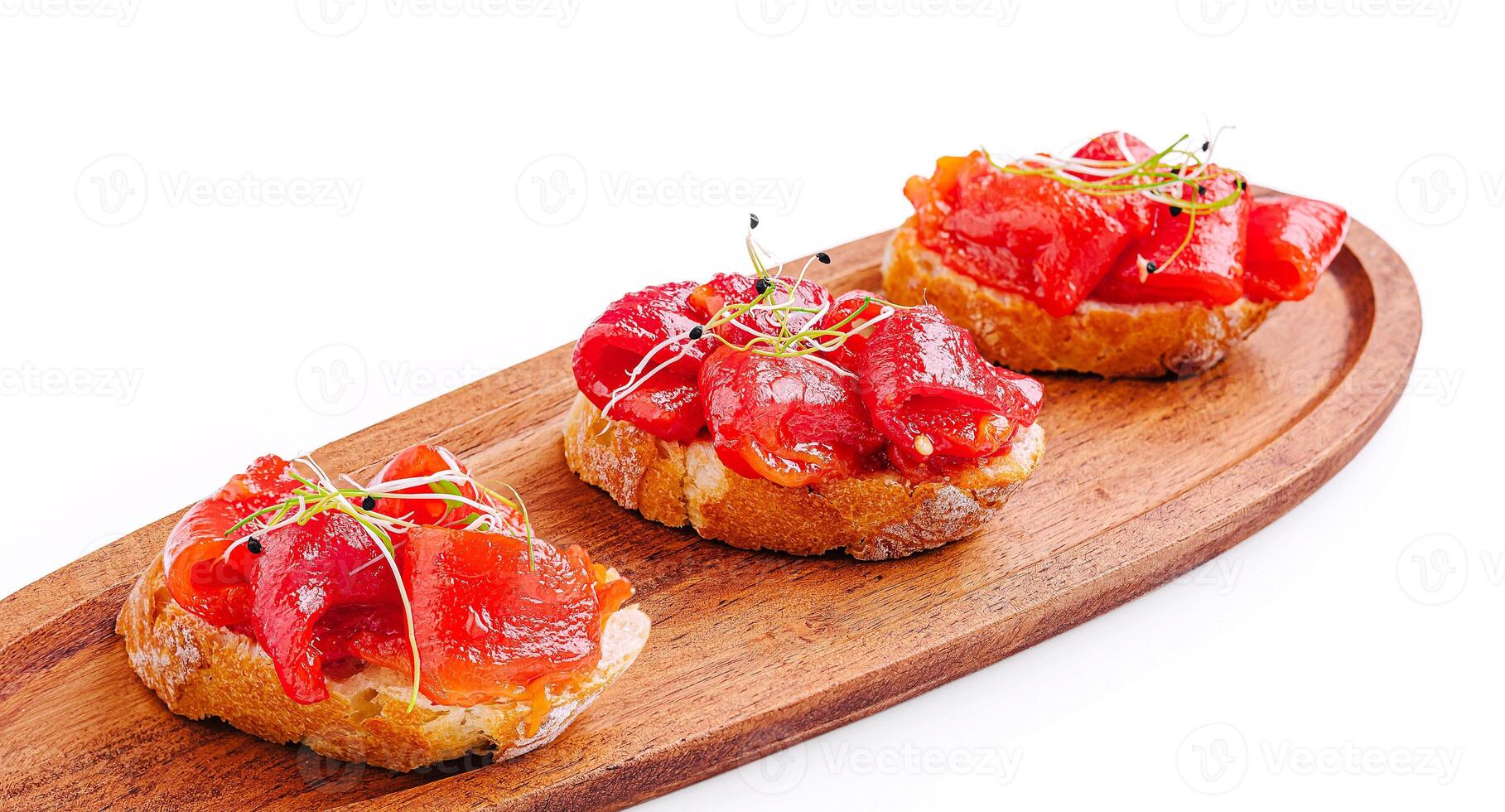 Delicious tapas with cured meat on a wooden serving board photo