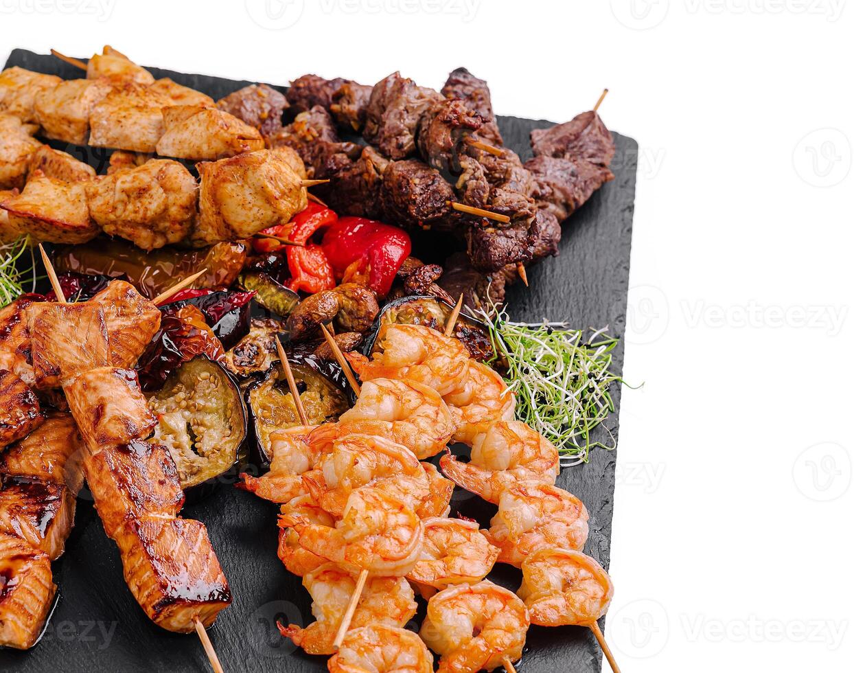 Delicious mixed grill platter featuring skewers of meat and seafood photo