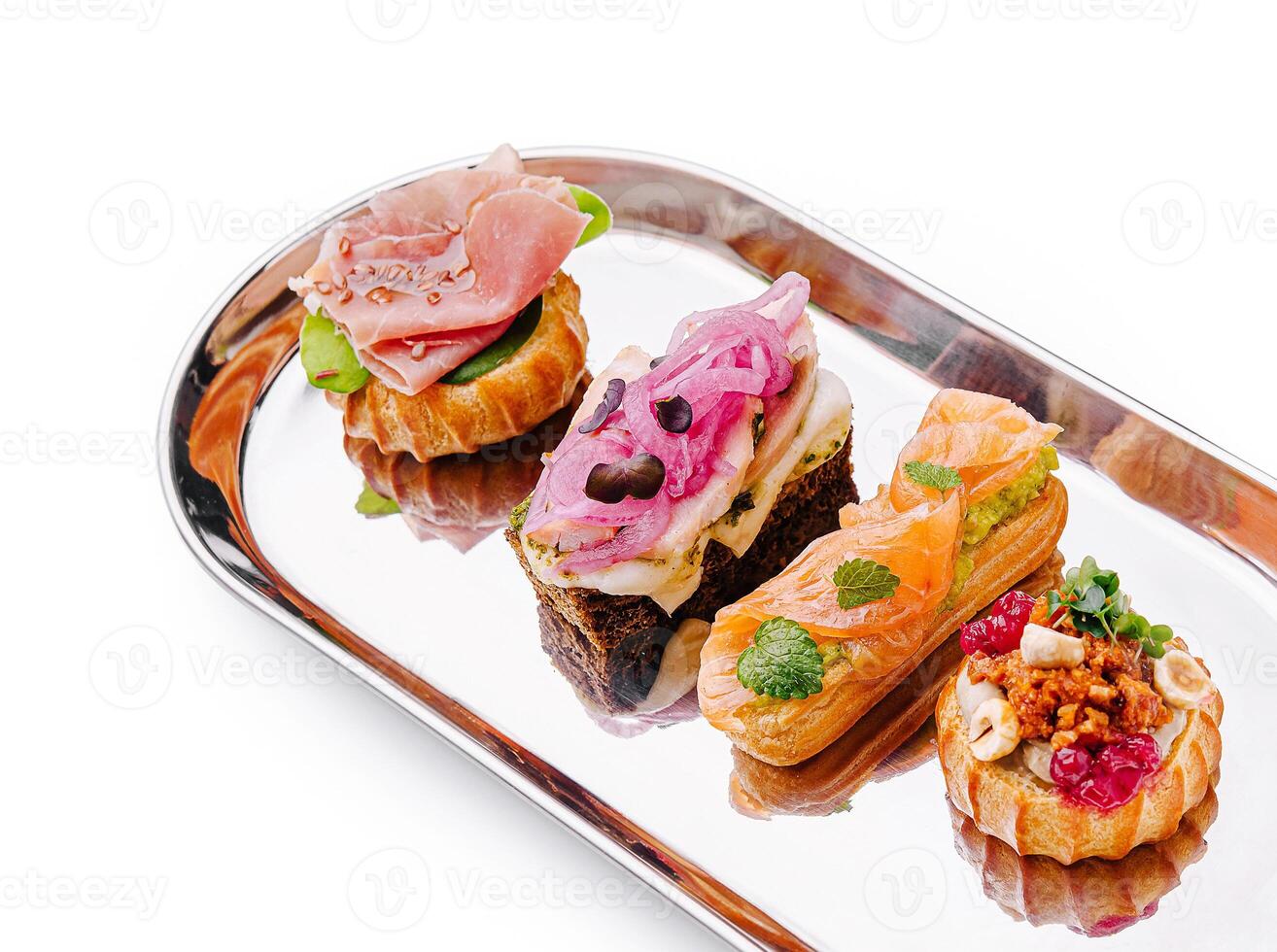 Gourmet canapes served on a silver platter at a stylish event photo