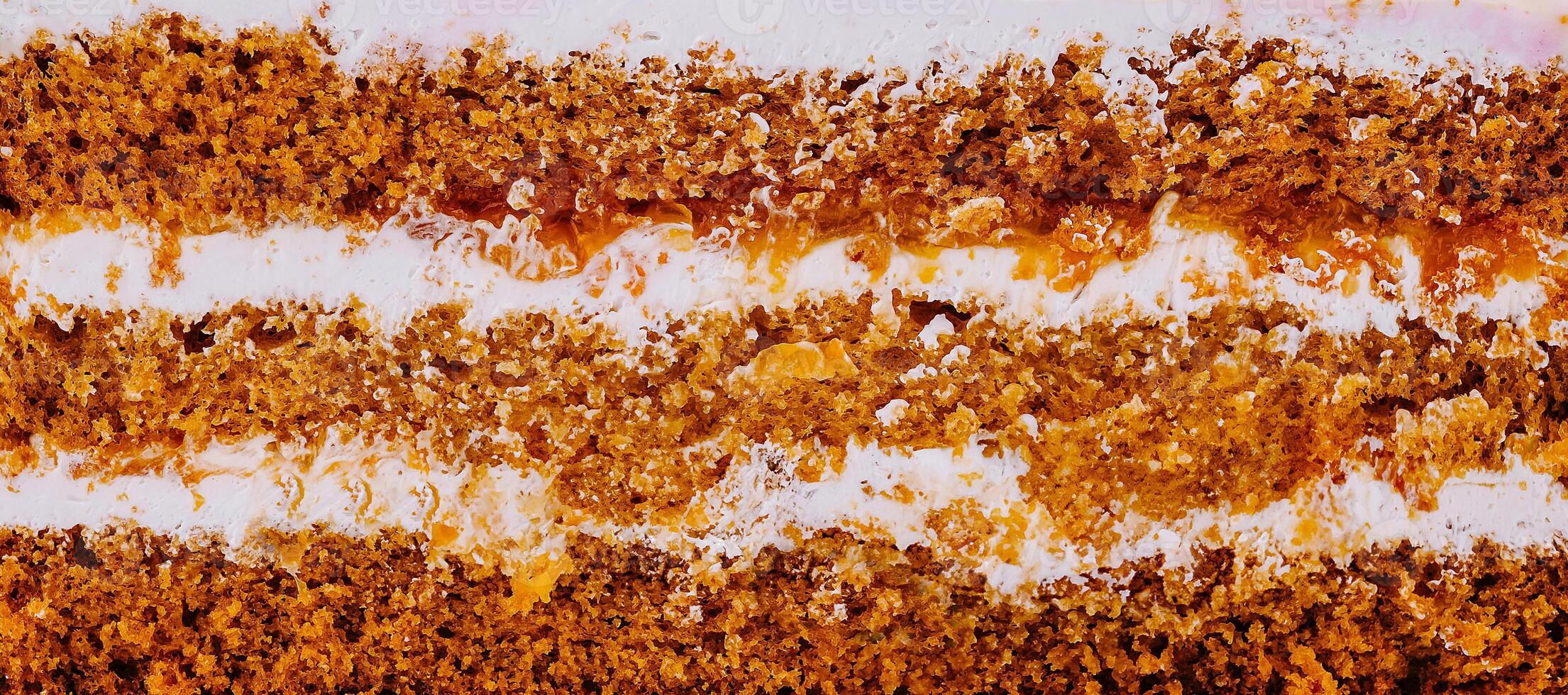 Delicious cake layers showing filling and frosting texture close up photo