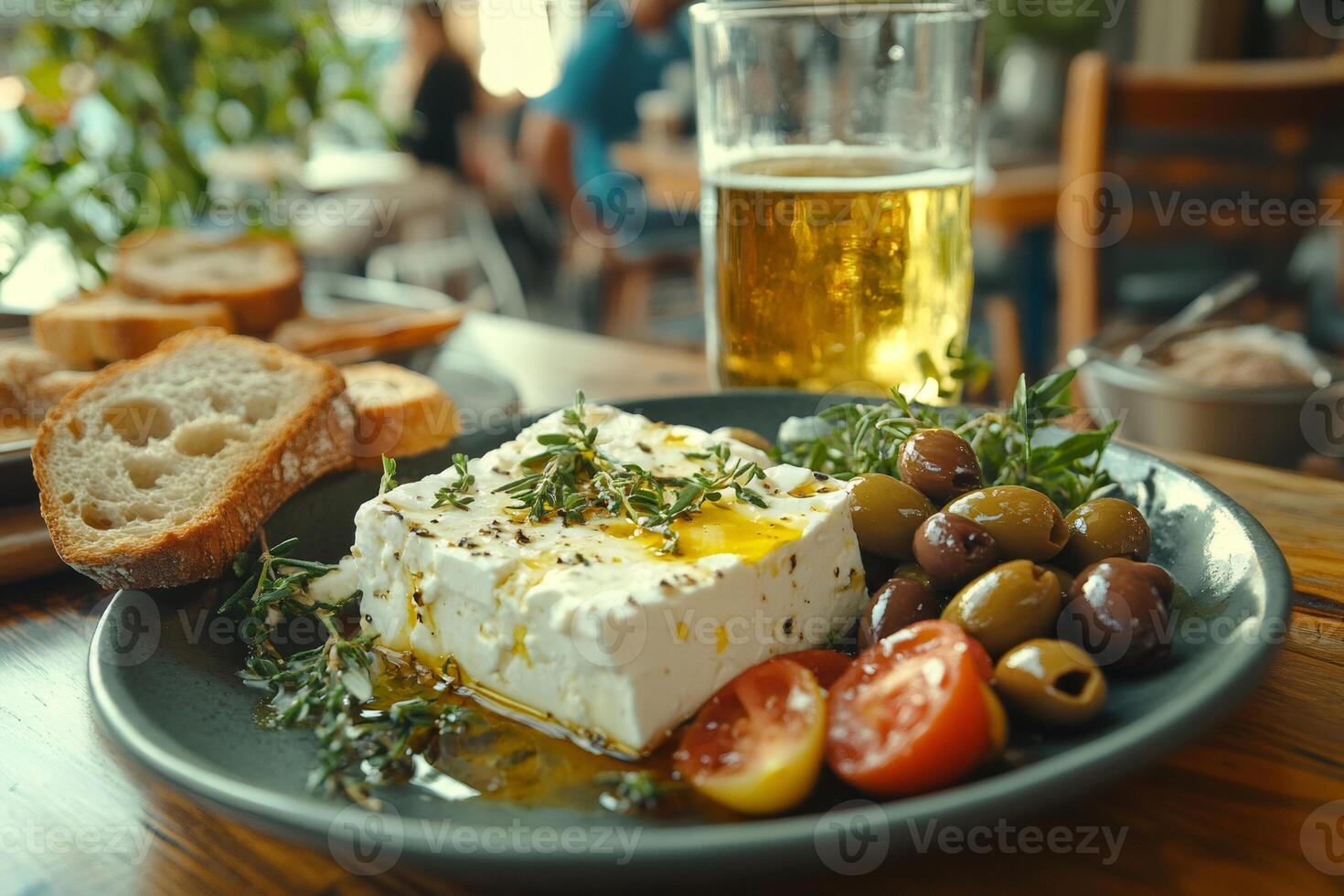 Traditional greek appetizer with feta cheese, olives, tomatoes, and beer enjoyed outdoors photo