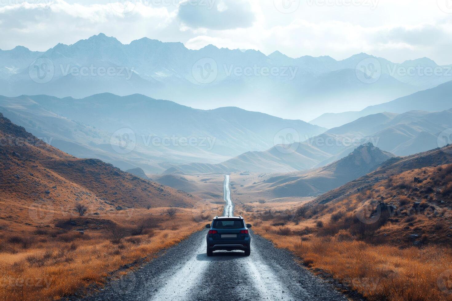 Suv driving on dirt road towards majestic mountains in autumn photo