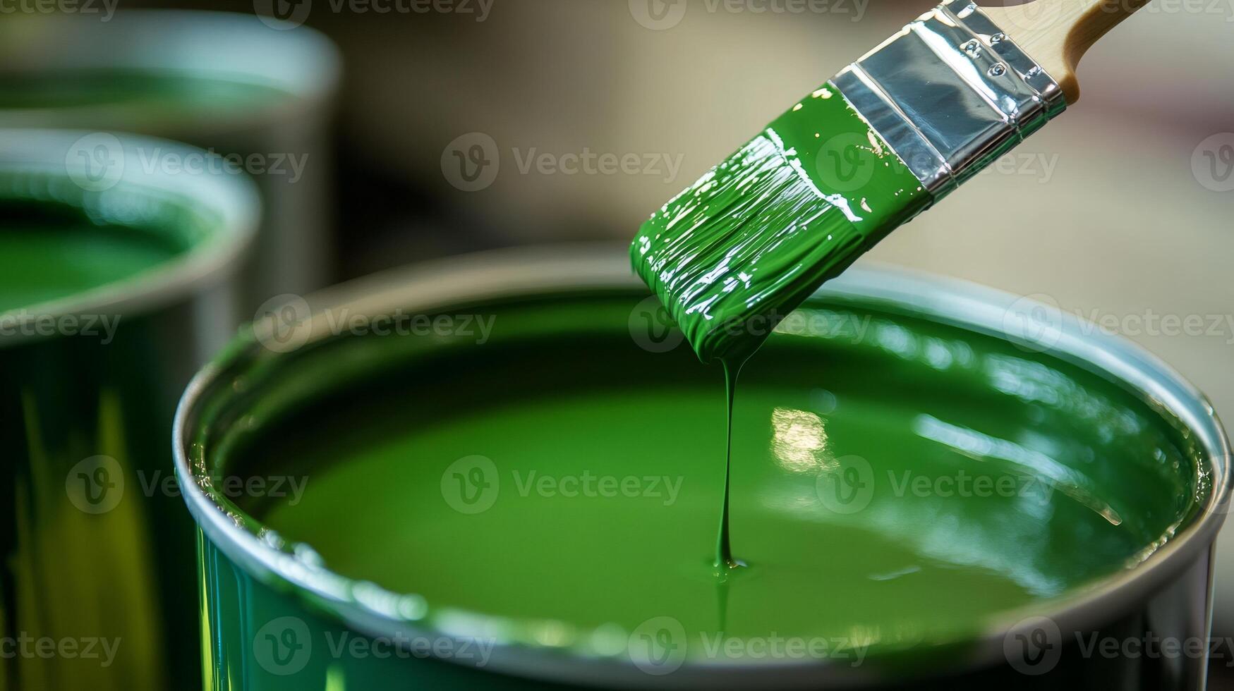 Paintbrush dripping green paint into a can with other cans in background photo