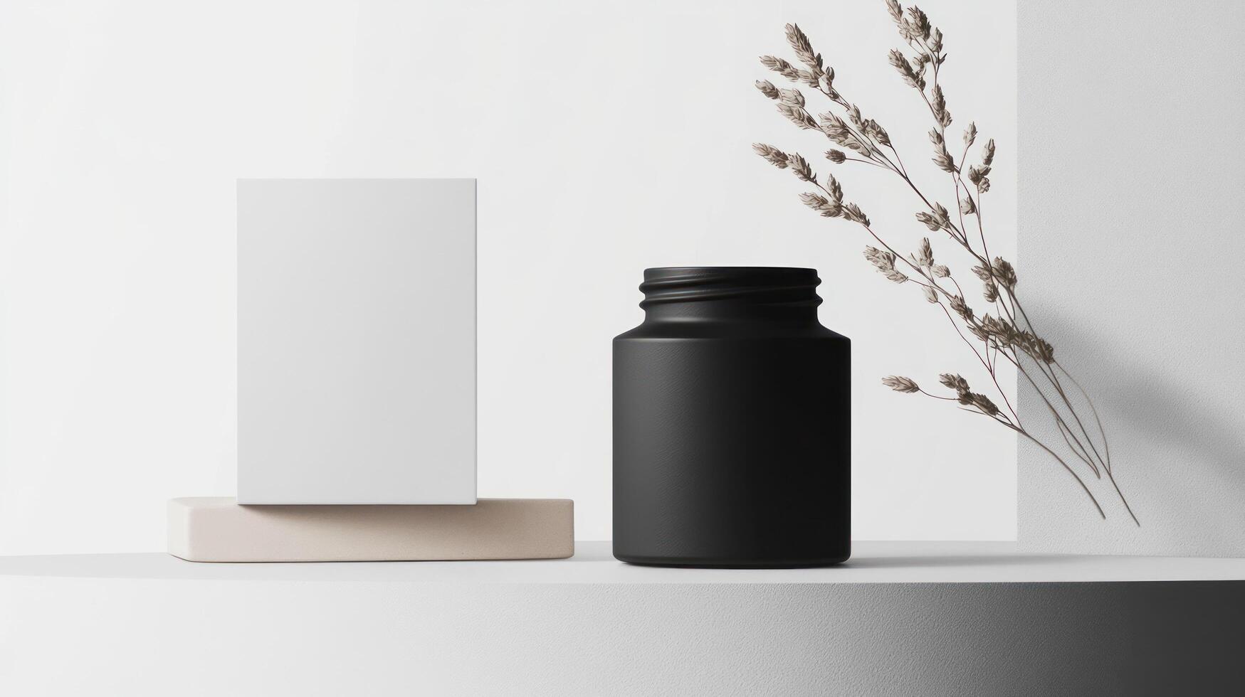 A black bottle and a white box on a white surface photo
