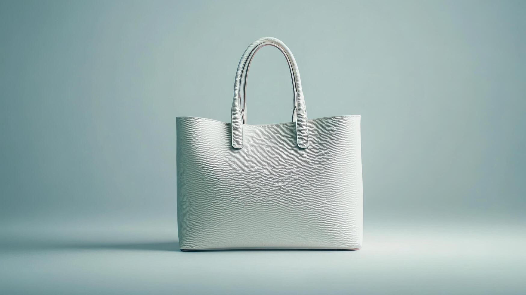 A white leather tote bag on a gray background photo