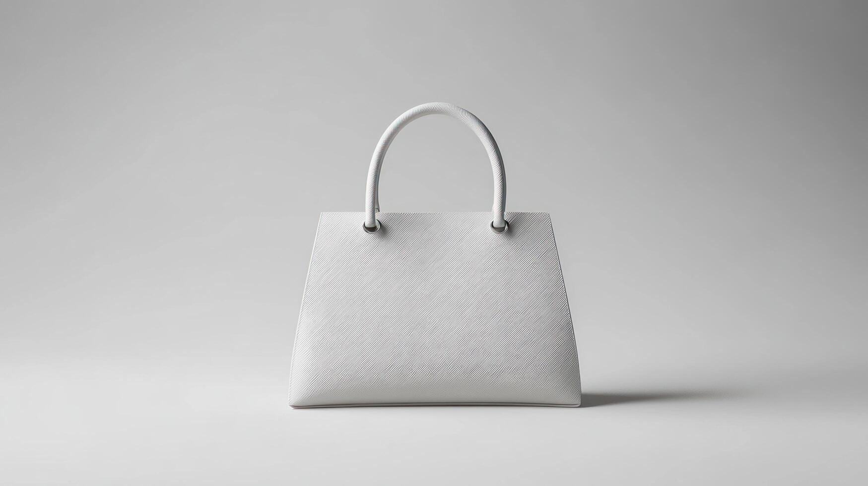 A white bag with handles on a gray surface photo