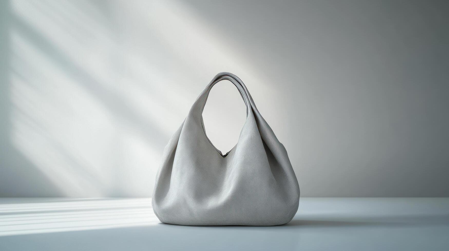 A white purse sitting on a table in front of a window photo