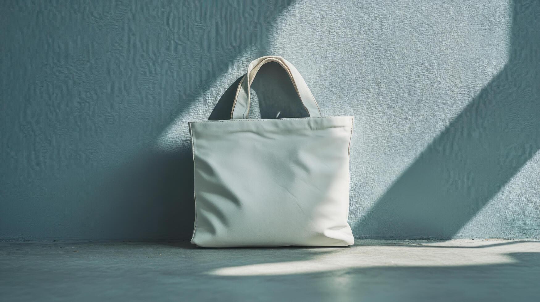 A white tote bag sitting on a concrete floor photo