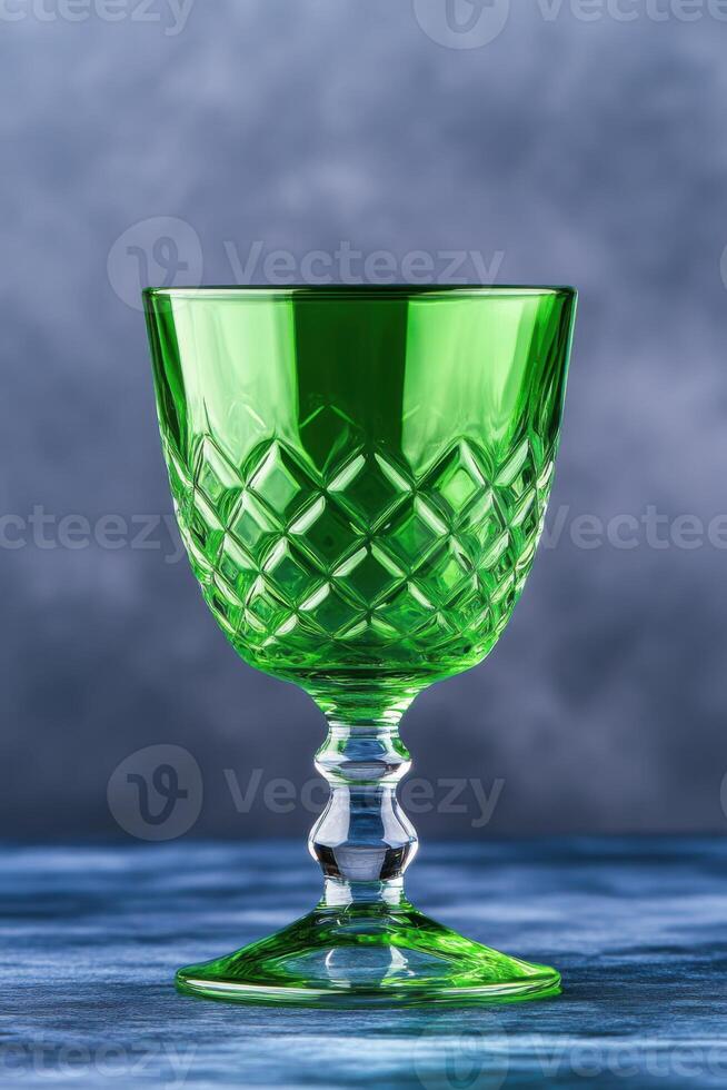 Elegant green crystal glass with diamond pattern on a blue background highlighting its delicate design photo
