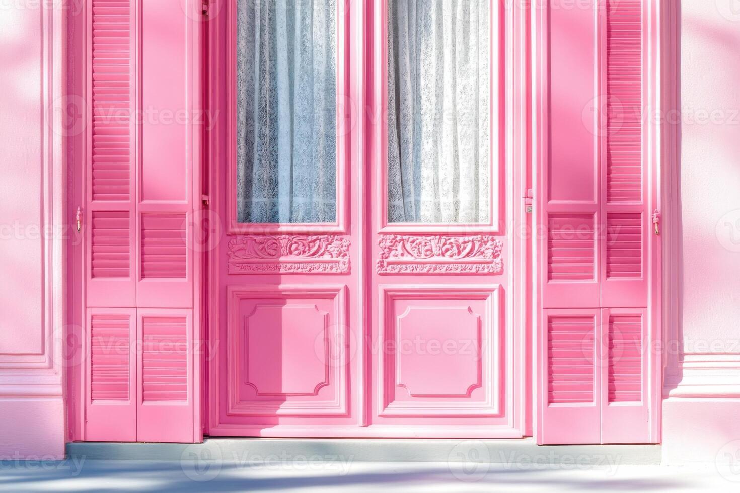 Bright pink door with elegant detailing and soft white curtains in a charming building during daylight photo