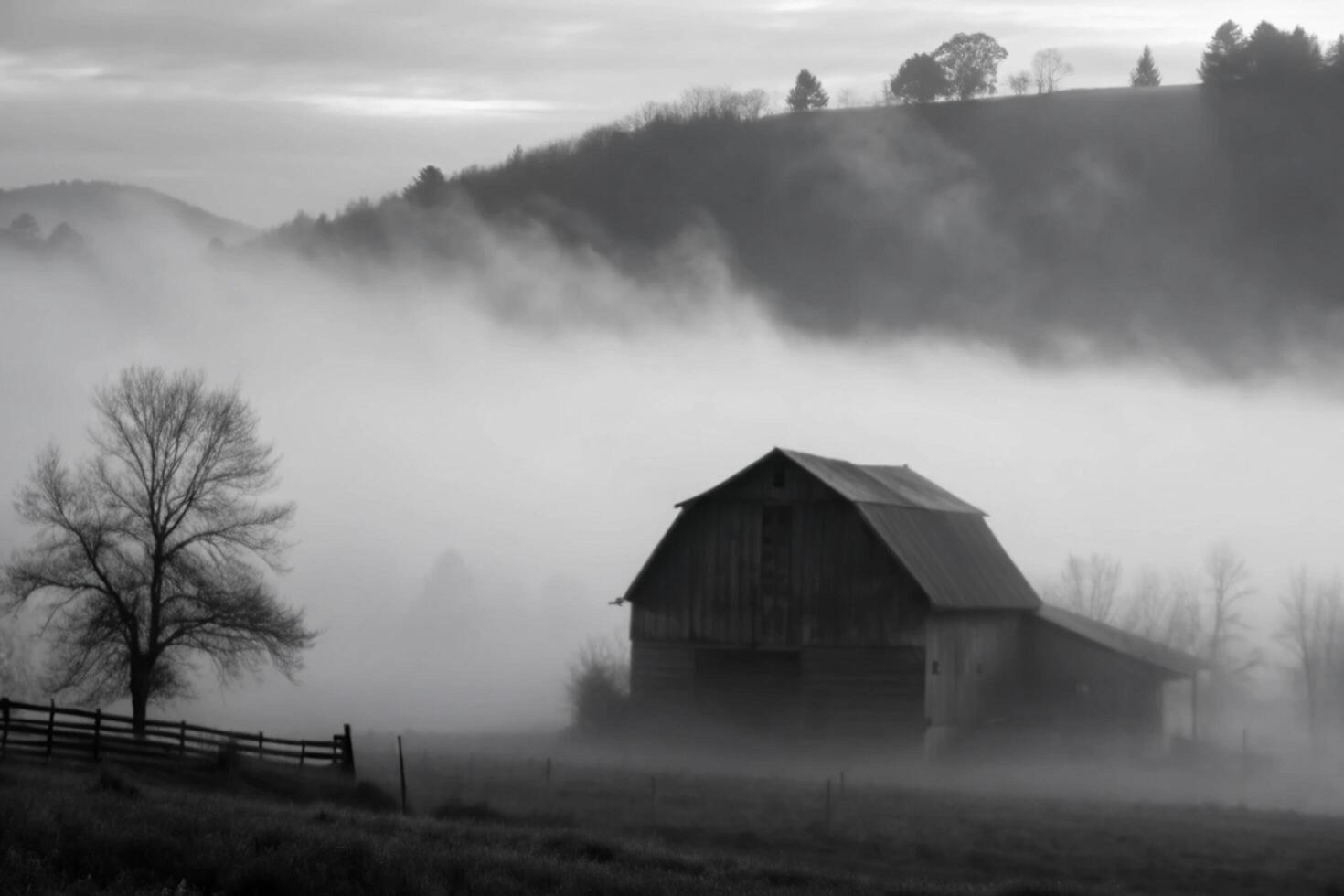 Misty Morning Fog Envelops a Rustic Barn in a Picturesque Valley photo