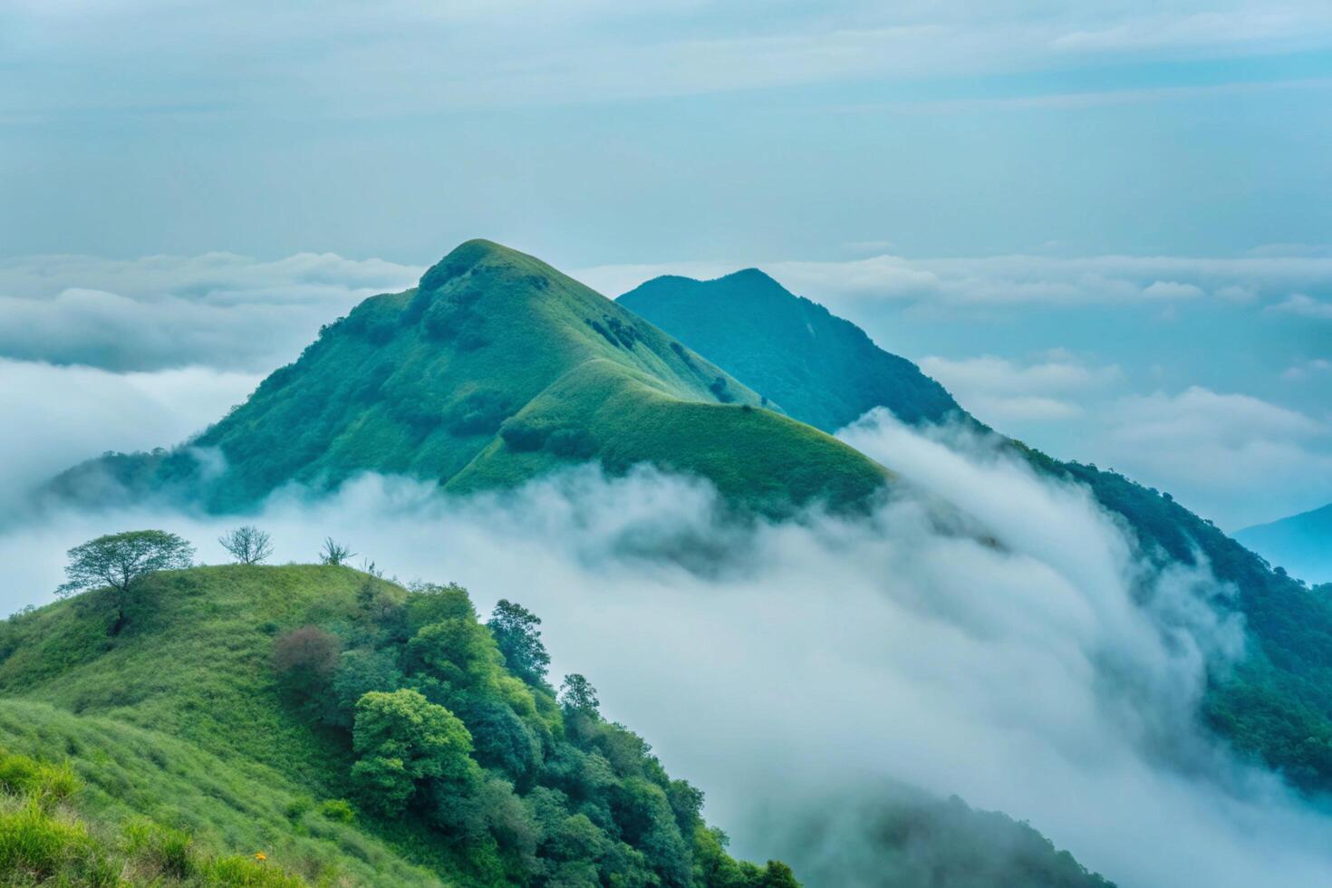Majestic Mountain Peaks Enveloped in a Sea of Clouds A Breathtaking Panorama of Lush Green Hills and Misty Valleys photo