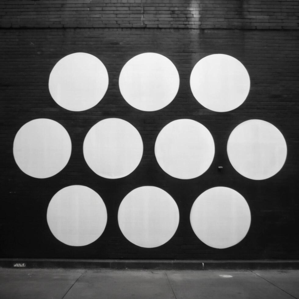Nine White Circles on a Black Brick Wall Urban Street Art Minimalist Geometric Design photo