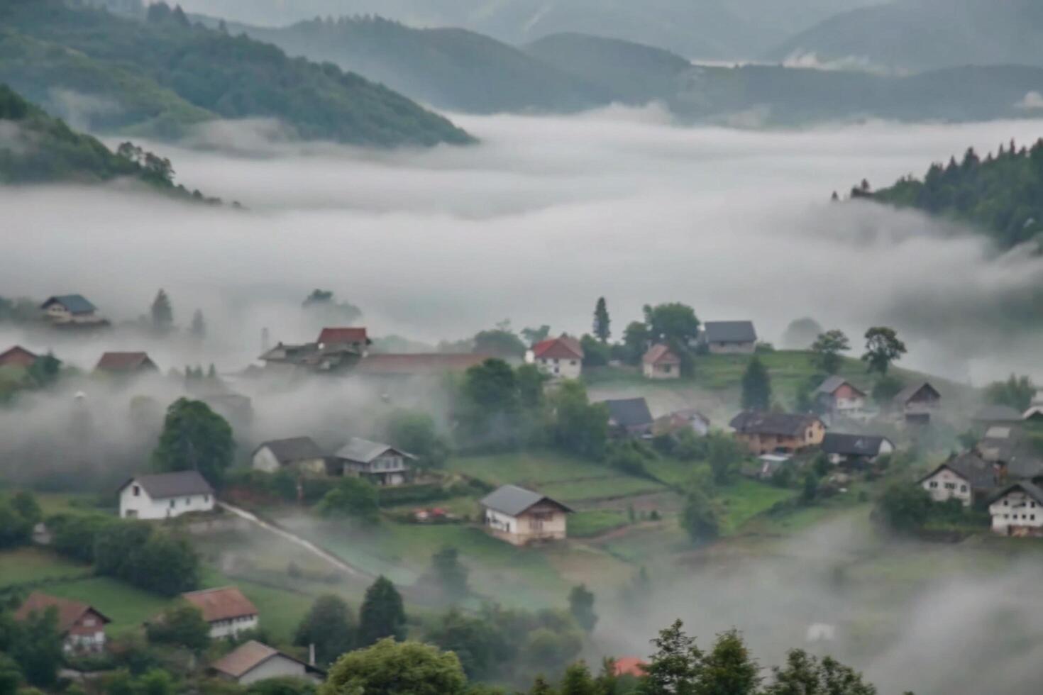 Misty Mountain Village A Serene Landscape of Houses and Rolling Hills Shrouded in Fog photo