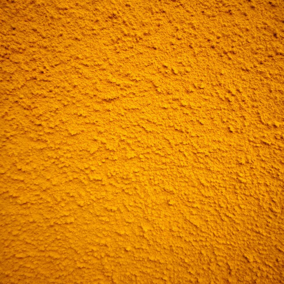Closeup of a textured orange wall surface showing bumpy and grainy details photo