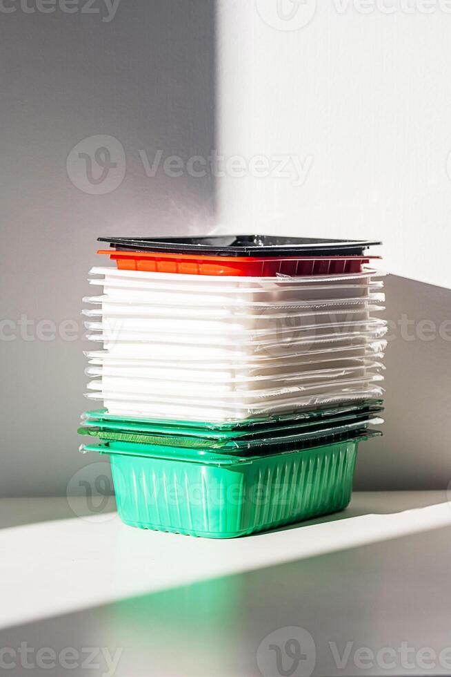 Pile of disposable plastic food containers ready for sorting and recycling. photo