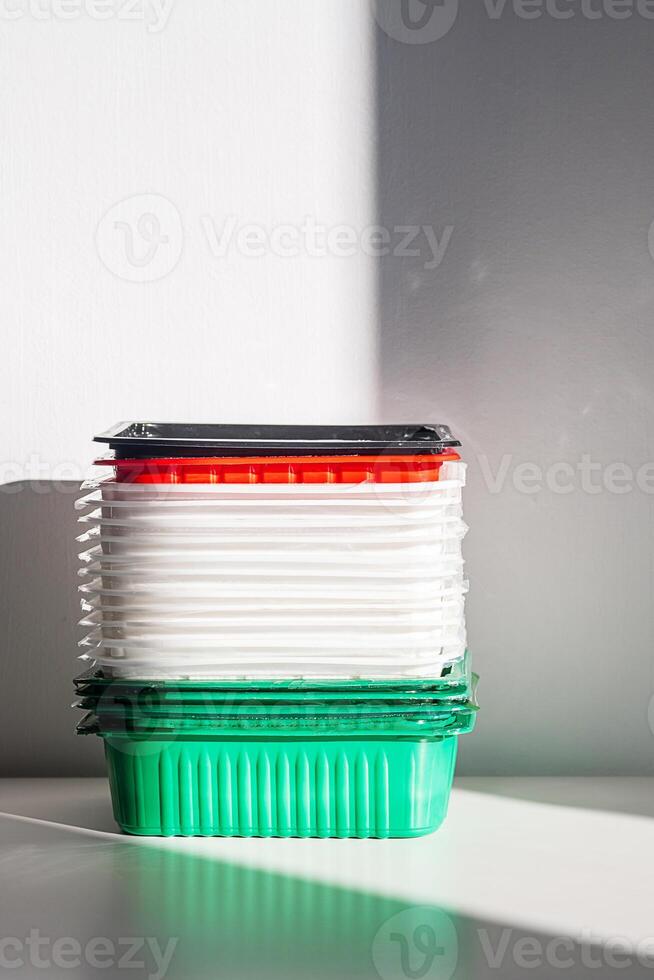 Pile of disposable plastic food containers ready for recycling. photo