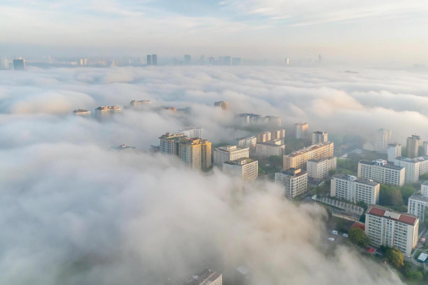 Cityscape engulfed in a thick blanket of morning fog a breathtaking aerial view of urban landscape photo