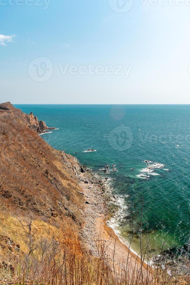 View of the vastness of the Pacific Ocean from the high seashore.... High cliffs on the shore of the Pacific Ocean. photo
