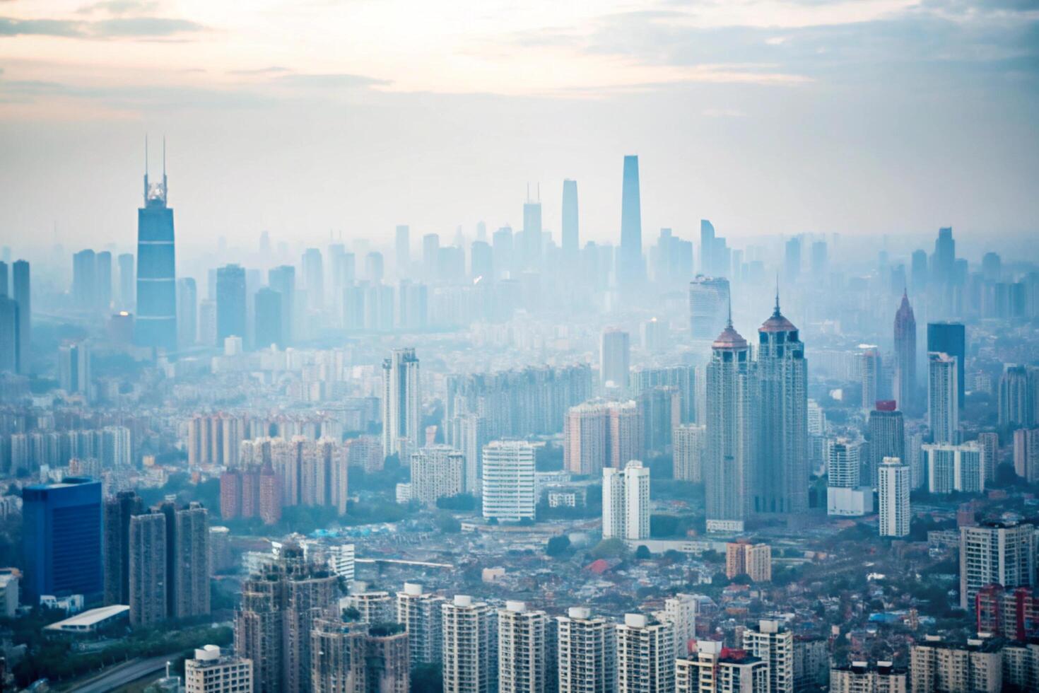 A hazy sunrise over a vast cityscape of skyscrapers and highrise buildings photo