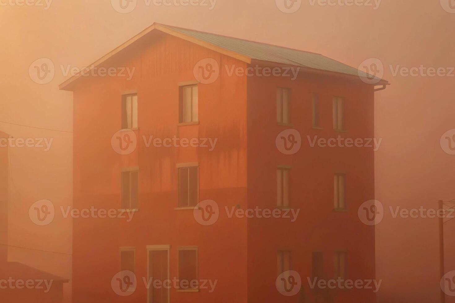 Orange building in hazy morning fog, three stories tall with many windows photo