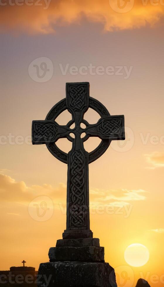 An intricately designed Celtic cross illuminated by a golden sunset, symbolizing heritage and faith, set against a mystical landscape that evokes a sense of peace and reverence. photo