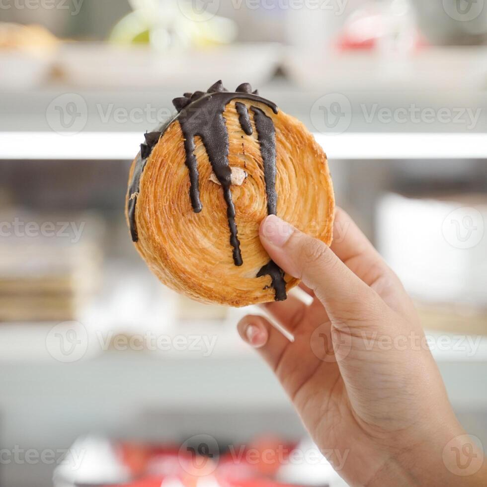 Ladies Hand Holding Cromboloni Chocolate photo