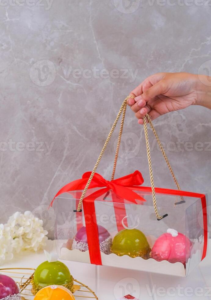 Ladies Hand Holding Dome Cakes Hampers for Valentines Days photo