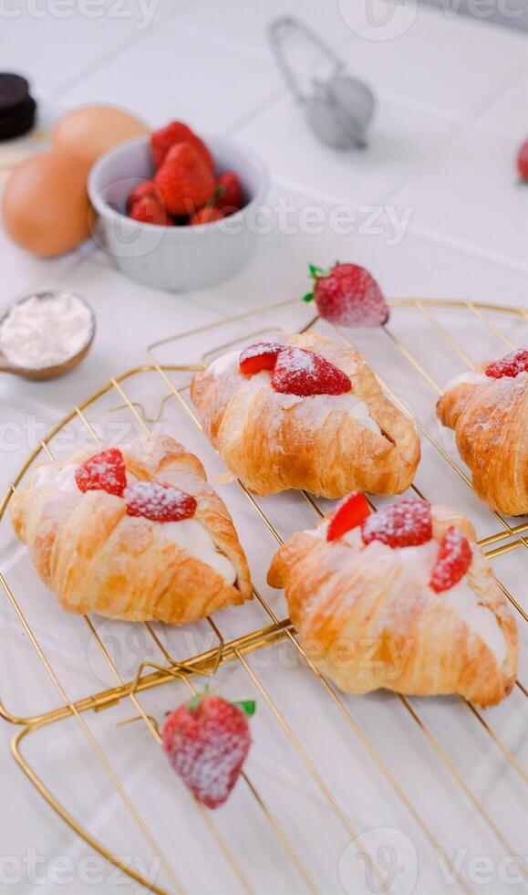 Close Up Photography of Mini Croissant Topped With Strawberry and Icing Sugar photo