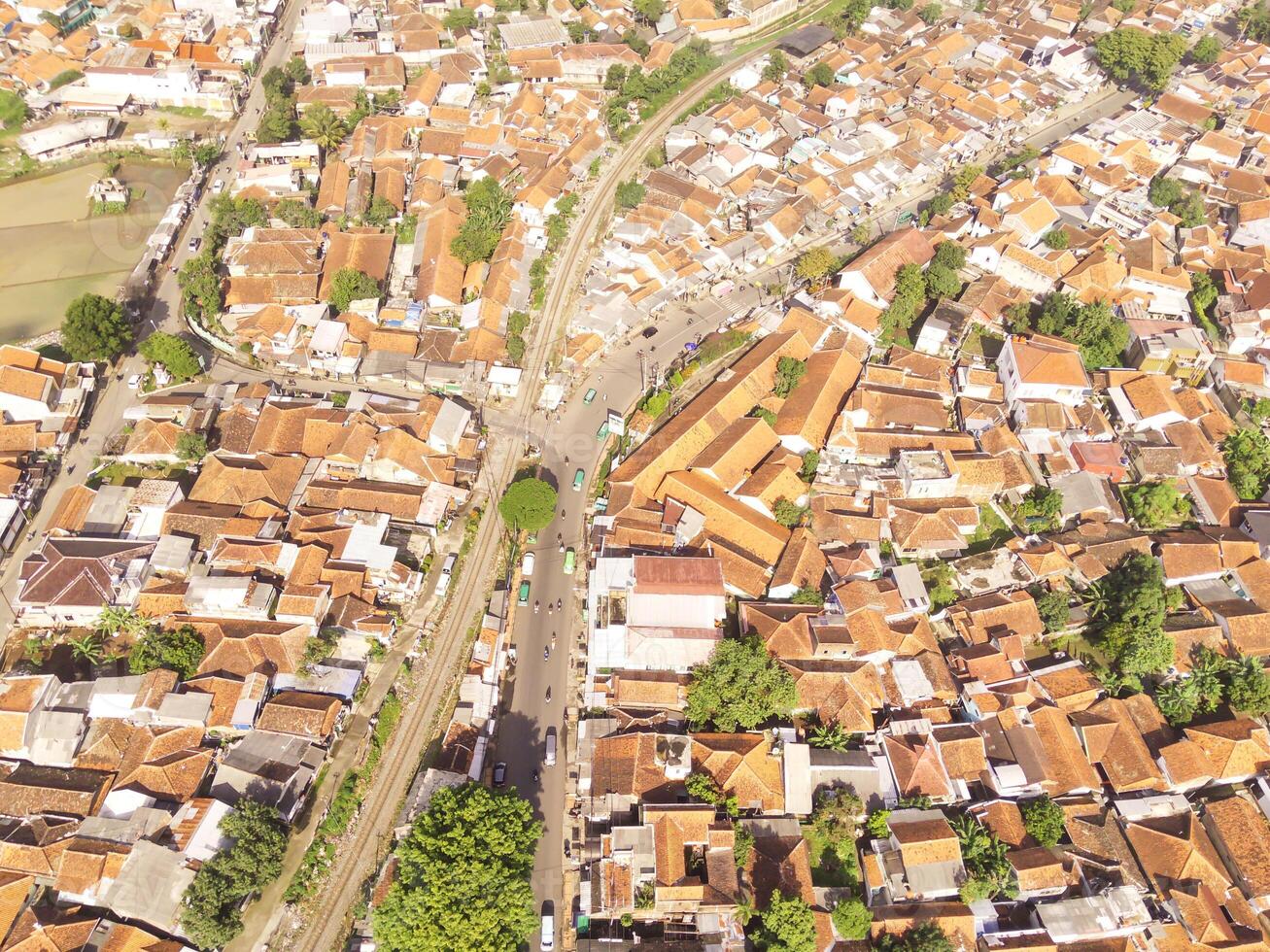 Indonesia. Panoramic landscape of the road junction at the railroad crossing. Cityscape of Cicalengka City from a height of 200 meters. Aerial shot from drone. Wallpaper Backgrounds. photo