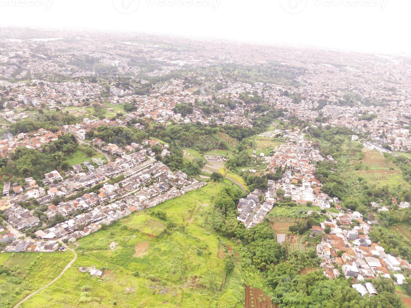 Panoramic settlement along the plateau. Cityscape of Bandung from a height of 200 meters. Aerial shot from drone. Wallpaper Backgrounds. Negative Space photo