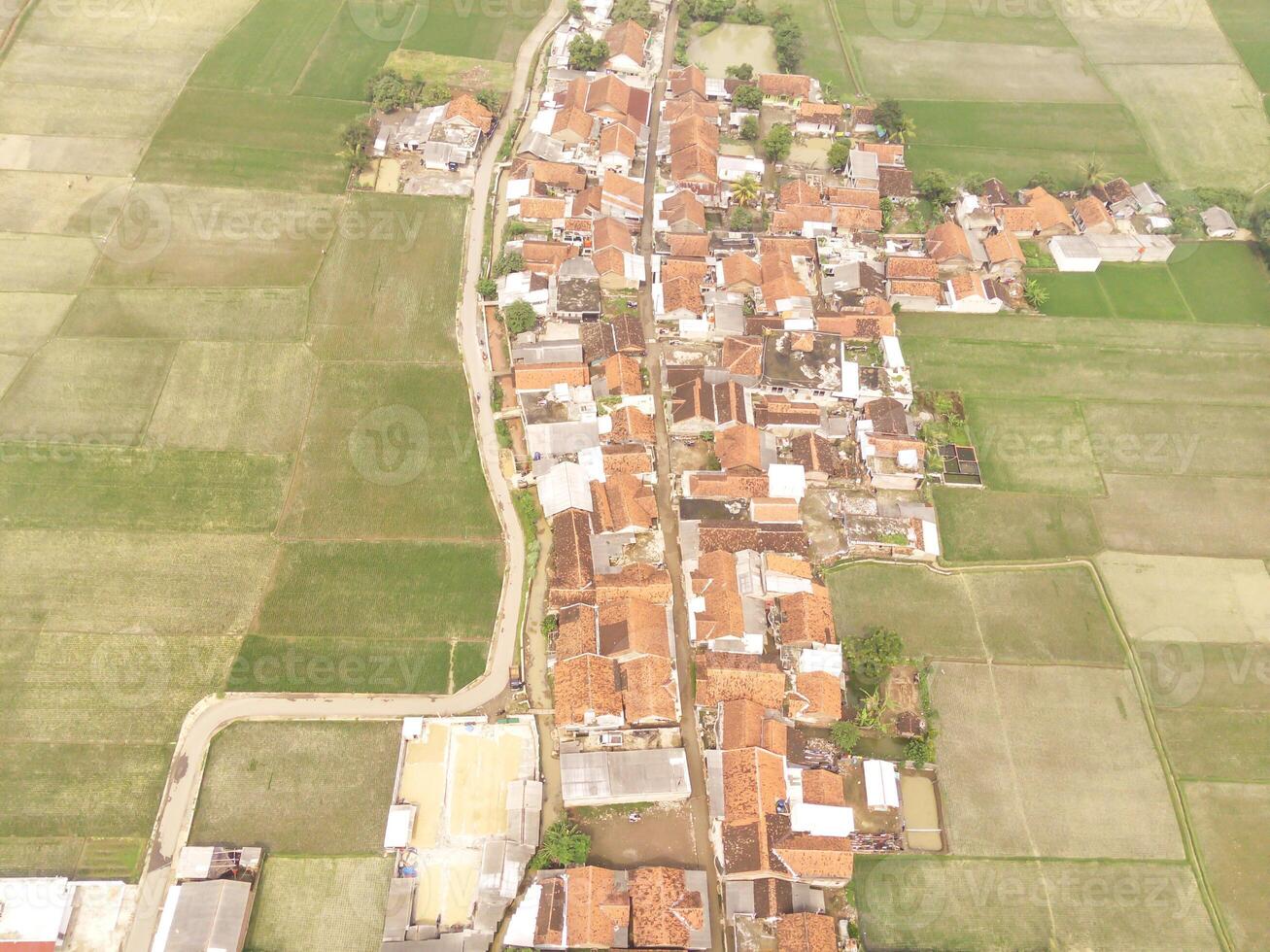 Cikancung, Indonesia. Aerial Landscape view of a remote village surrounded by rice field patches. Residential District and agricultural fields. Panorama rural and suburban. Asia photo