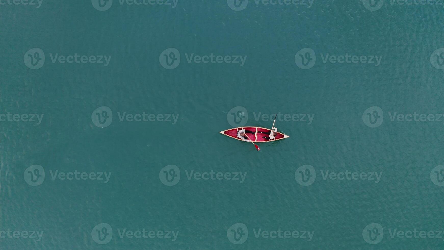 An aerial view of a small boat in the water photo