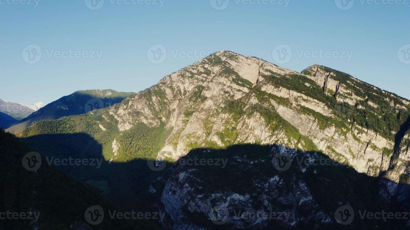 A mountain range with a shadow cast on it photo