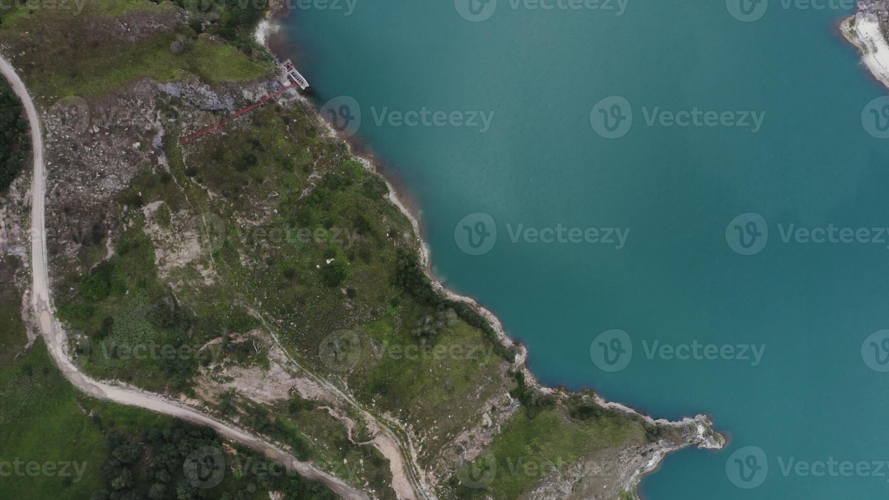 An aerial view of a lake and a road photo