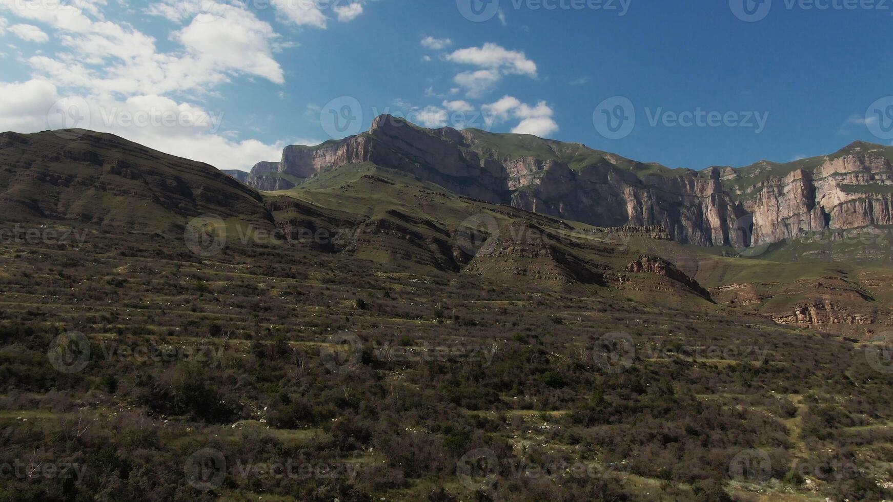 A mountain range with a valley in the background photo