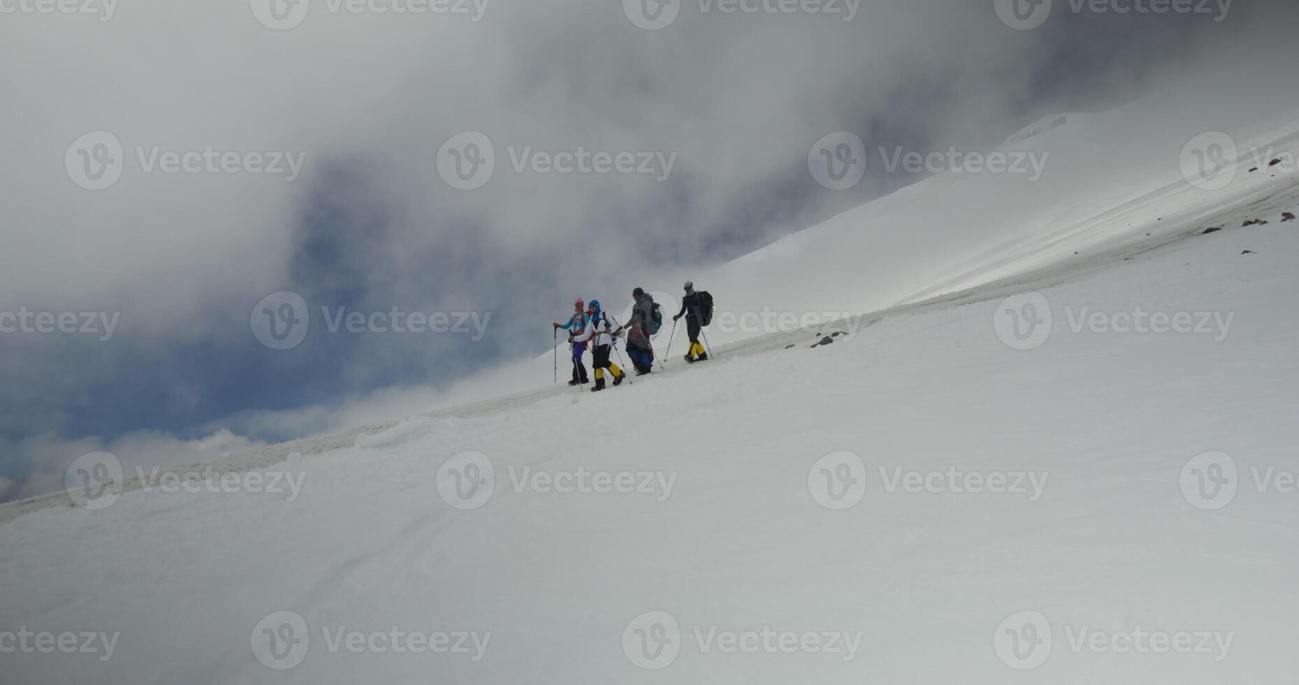 A group of people standing on a snowy slope photo