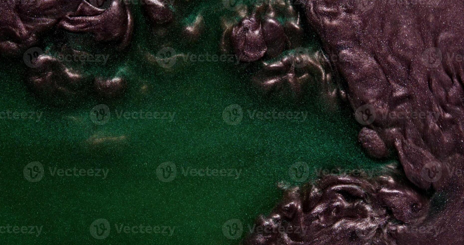 Two dark glitter paint blend actively gurgle and create abstract patterns photo