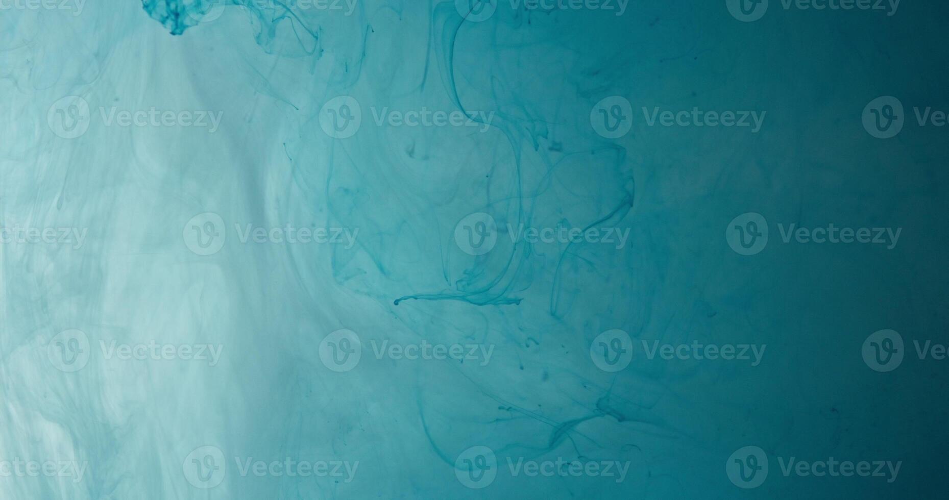 A blue liquid is flowing in a dark room photo