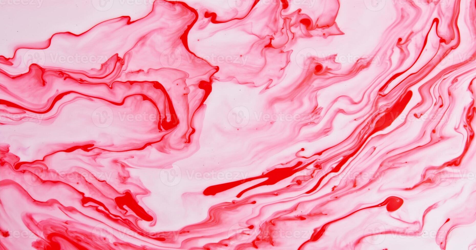 A red and white paint is being poured into a bowl photo