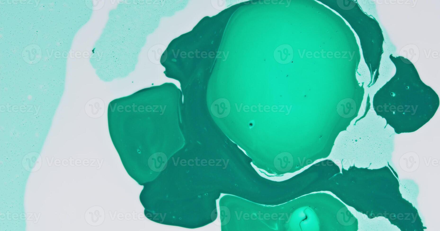 A green and white paint splattered on a white surface photo