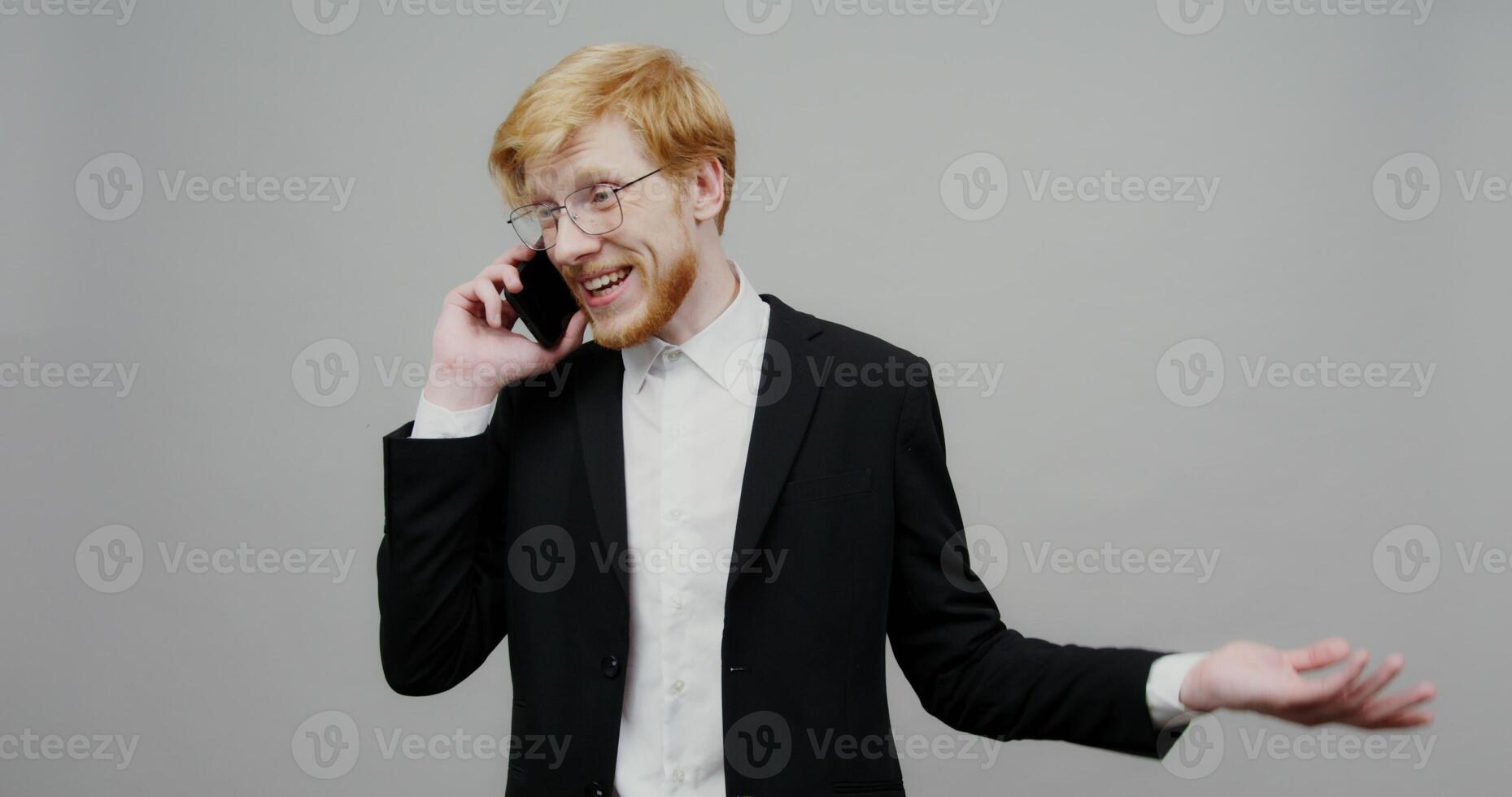 A man in a suit talking on a cell phone photo