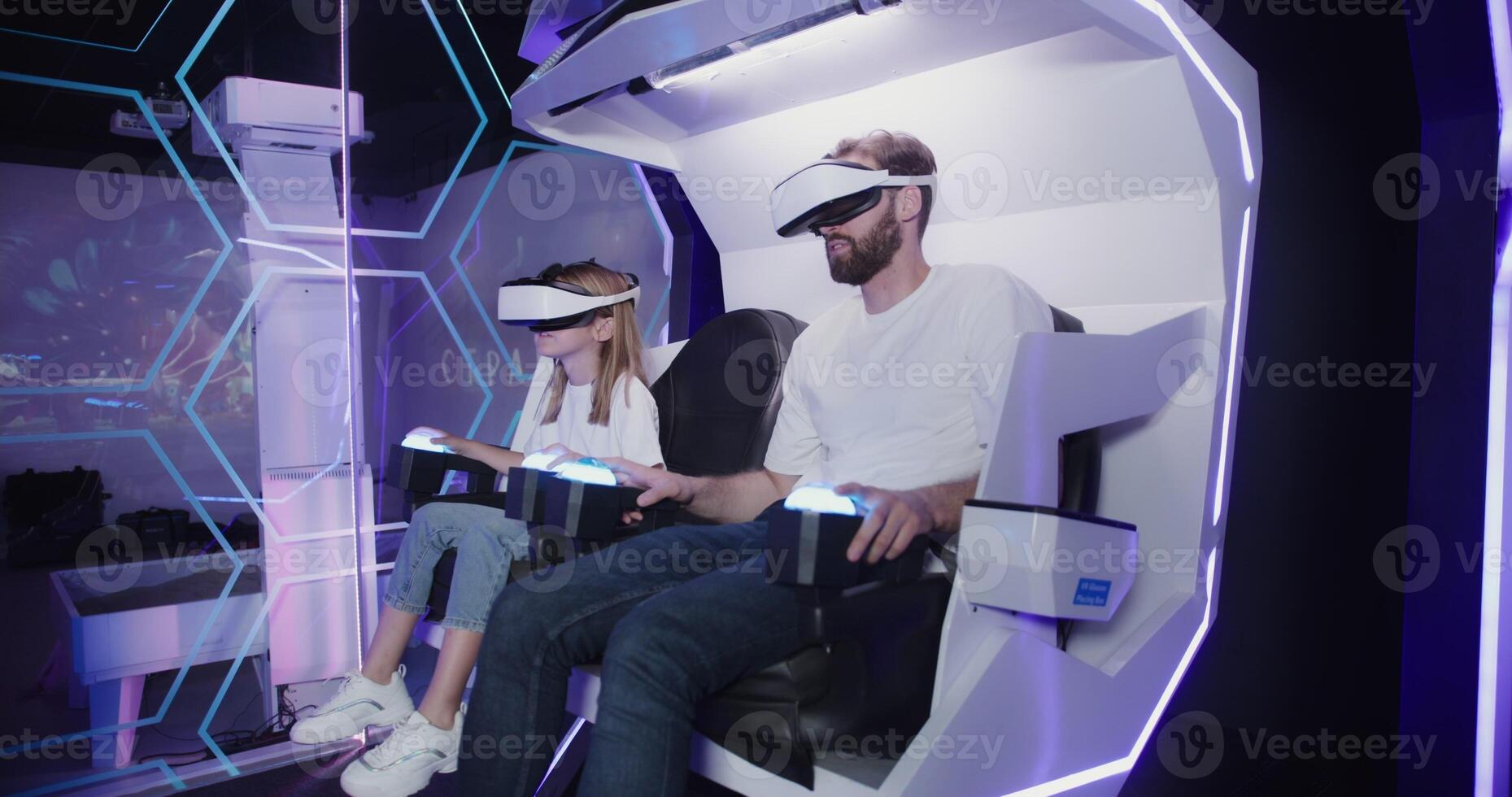 Two people in vr headsets sitting in a chair photo