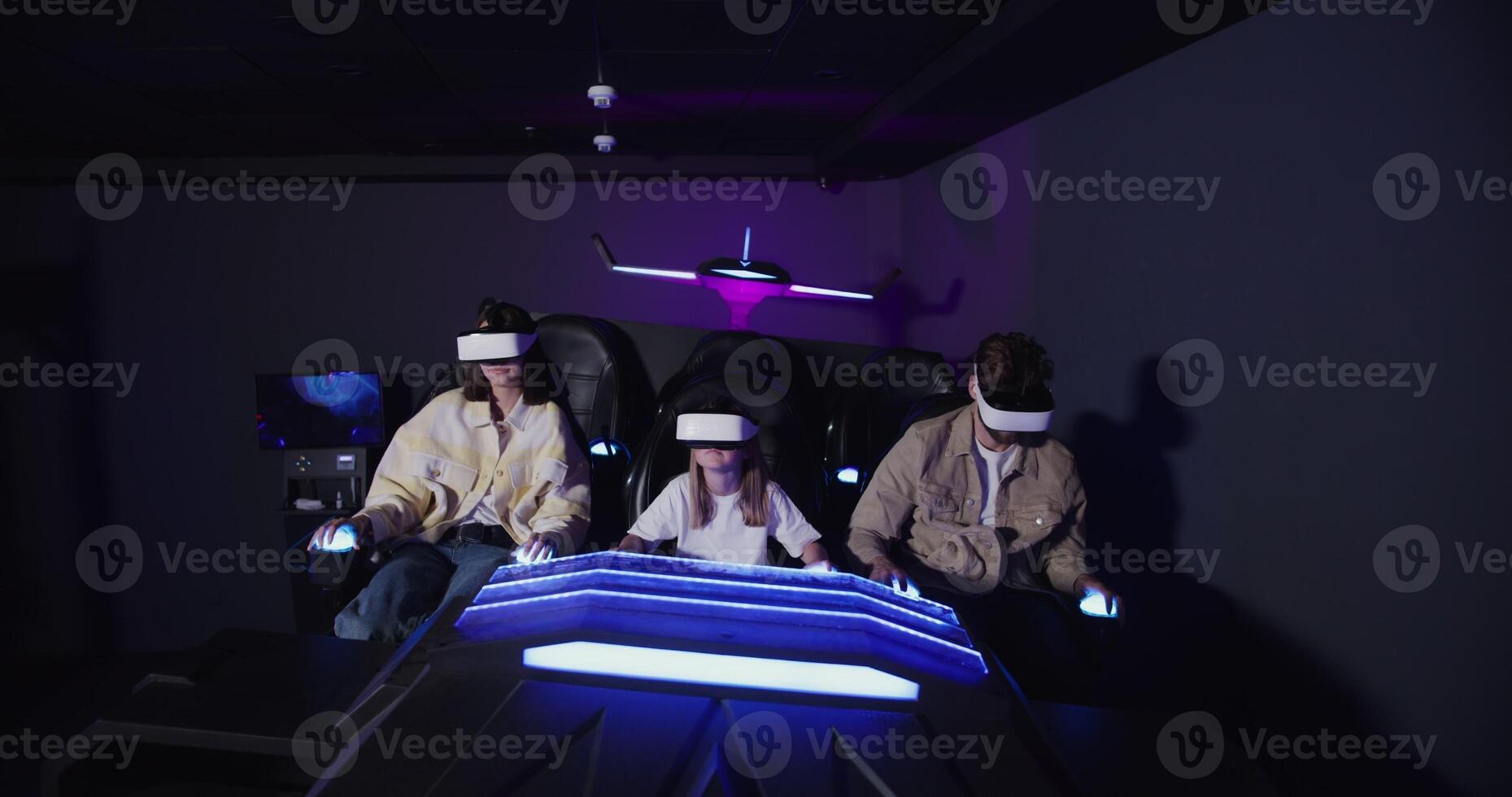 Three people in a room with a virtual reality headset photo