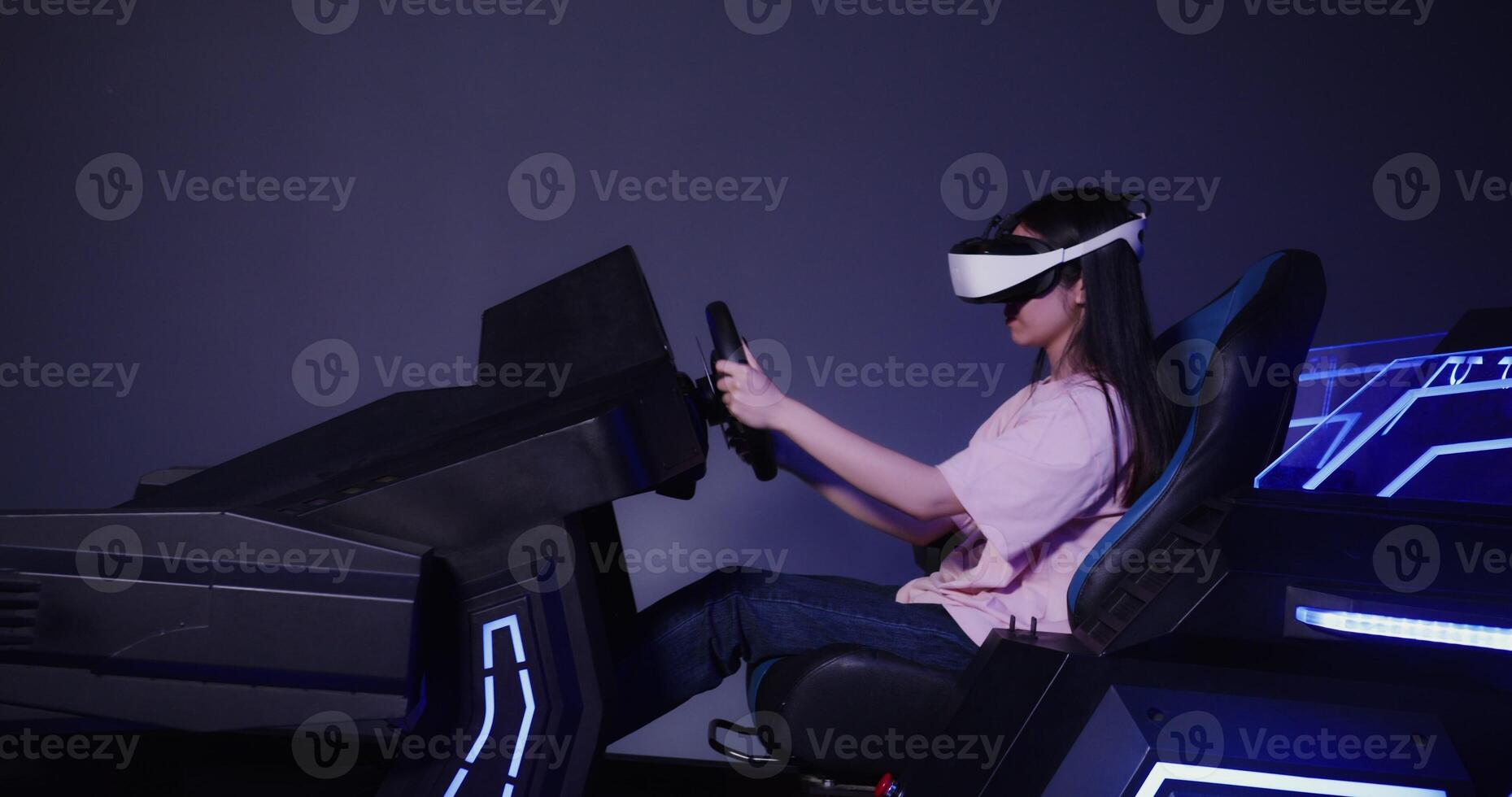 A woman wearing a virtual reality headset is driving a car photo